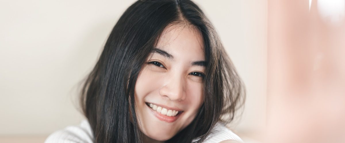 AdobeStock_459840199 Selfie of profile picture young adult asian woman. Happy smile people in the morning wellness lifestyle concept.